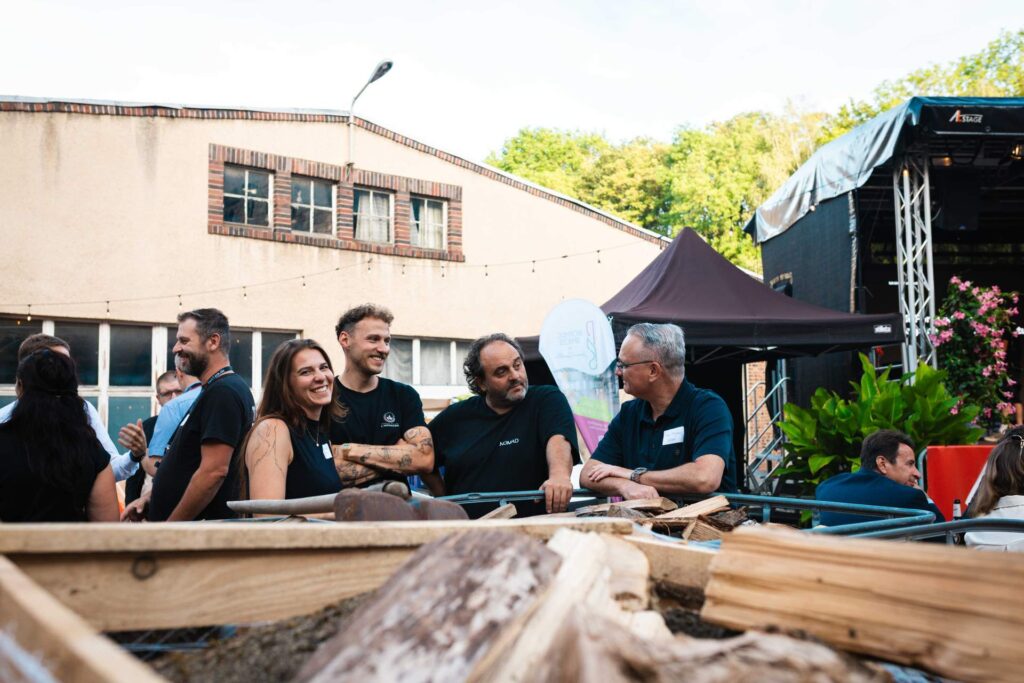 Gruppe von Teilnehmern im Austausch auf dem Außengelände der ROGO-Werke.